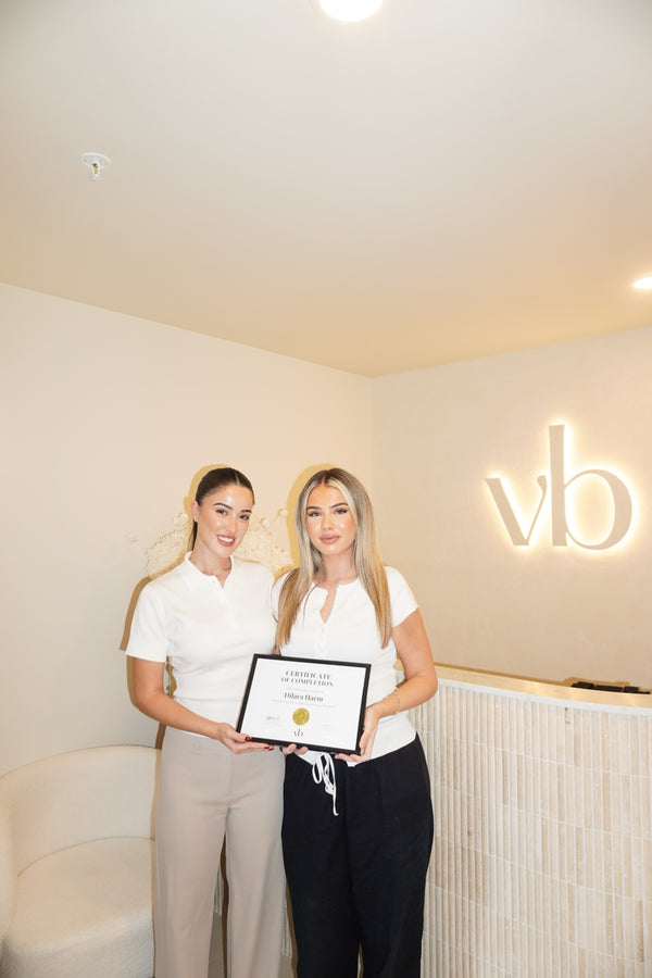 Vlach Beauty graduate holding certificate