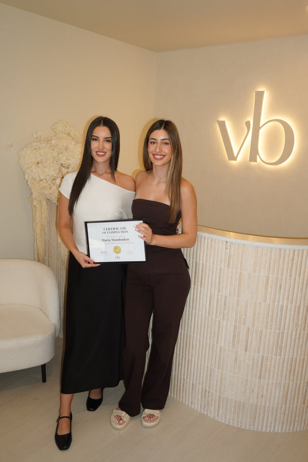 Vlach Beauty graduate holding certificate