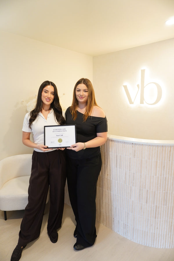 Vlach Beauty graduate holding certificate