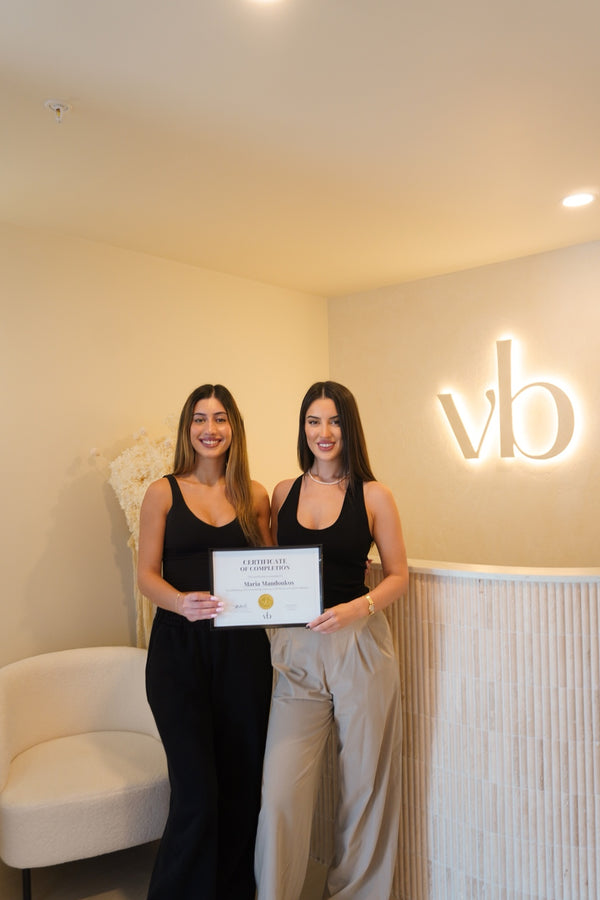 Vlach Beauty graduate holding certificate