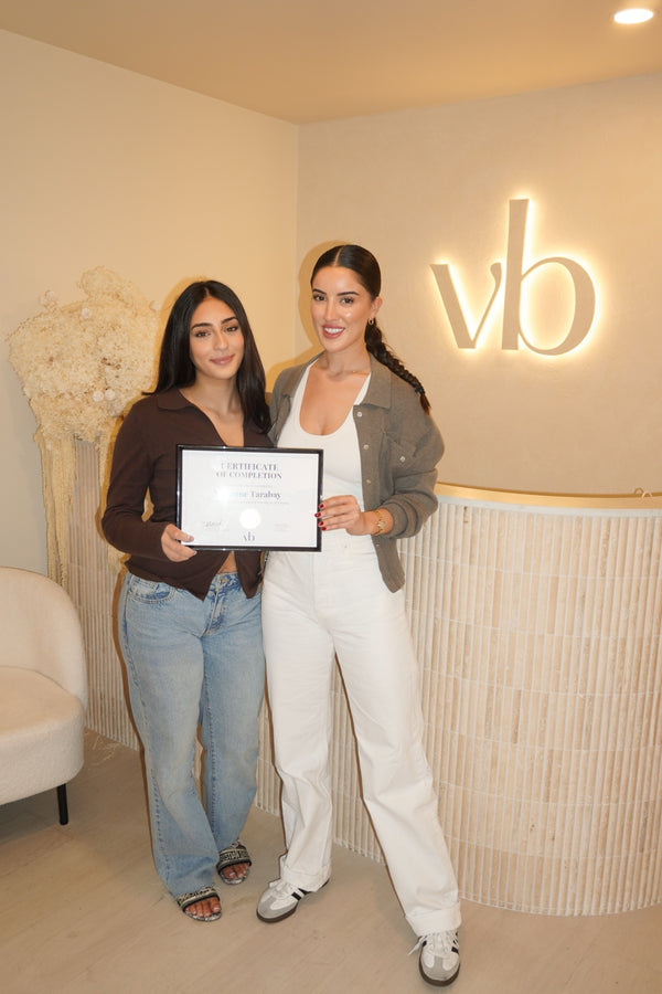 Vlach Beauty graduate holding certificate