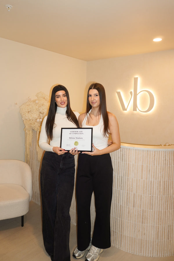 Vlach Beauty graduate holding certificate