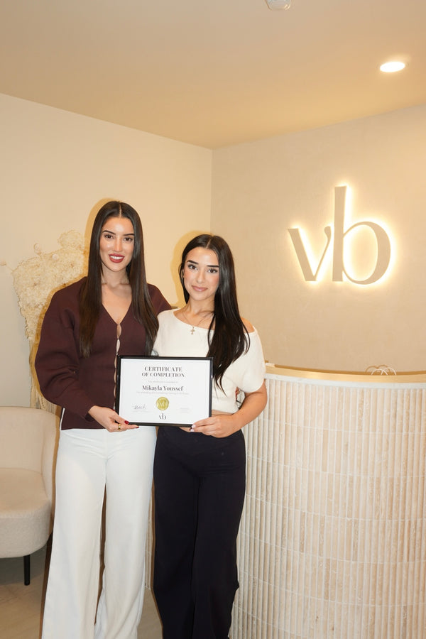 Vlach Beauty graduate holding certificate