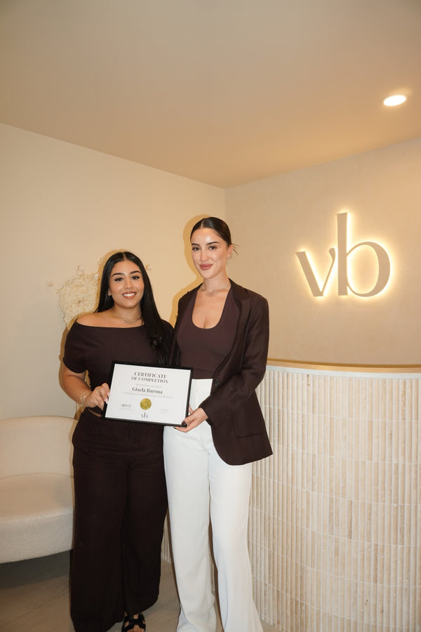 Vlach Beauty graduate holding certificate